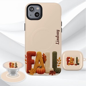 May include: A beige phone case, a matching earbud case, and a phone grip, all featuring the word FALL in a textured knit-style font with an orange pumpkin and autumn leaves. The phone case is personalized with the name Lindsay in brown text.