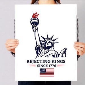 May include: A white rectangular poster featuring a dark blue graphic of the Statue of Liberty holding a torch with a red flame. Below the graphic, the text reads REJECTING KINGS SINCE 1776, flanked by red lines, with a small American flag icon below.