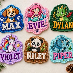 May include: Six embroidered patches with scalloped edges featuring cartoon characters and names. The patches display a puppy named MAX, a mermaid named EVIE, a dragon named DYLAN, a unicorn named VIOLET, a panda named RILEY, and a dinosaur named PIPER.