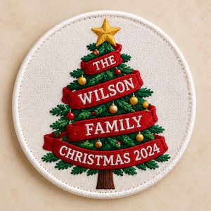 May include: A circular embroidered patch featuring a green Christmas tree with a gold star topper. Red ribbons wrap around the tree with white text reading THE WILSON FAMILY CHRISTMAS 2024. Small gold and red ornaments decorate the branches.