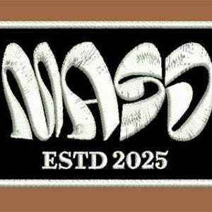 May include: Embroidered patch with the word "MASS" in white, stylized lettering on a black background. The text "ESTD 2025" is below the word. The patch has a white border and a brown background.