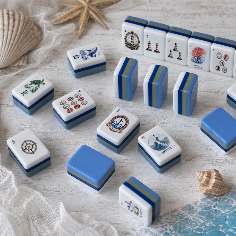 May include: A collection of rectangular mahjong tiles featuring nautical and coastal illustrations, including lighthouses, anchors, sea creatures, and compasses. The tiles have white faces with blue and green layered bases and some include text.