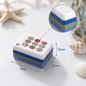 May include: A rectangular mahjong tile with a white top featuring nine nautical icons, including anchors and stripes. The side layers are blue, olive green, and blue. Dimensions are 31mm by 23mm by 15mm, as indicated by the blue measurement lines.