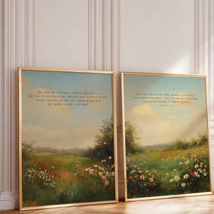 May include: Two framed landscape art prints with gold frames. The artwork depicts a field of flowers and trees under a cloudy sky. Each print has text at the top. The frames are rectangular.