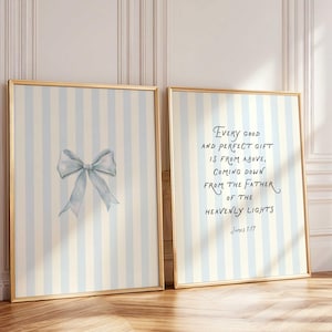 May include: Two framed prints with gold trim. One features a watercolor bow in light blue. The other print has text that reads "Every good and perfect gift is from above, coming down from the Father of the heavenly lights" James 1:17.