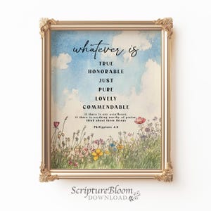 May include: A watercolor print with a gold frame featuring a quote from Philippians 4:8, "whatever is true, honorable, just, pure, lovely, commendable... think about these things." The quote is surrounded by a field of colorful flowers.