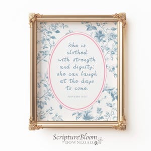 May include: A printable wall art design with a floral background and a pink oval with a blue text overlay. The text reads "She is clothed with strength and dignity; she can laugh at the days to come. Proverbs 31:25"