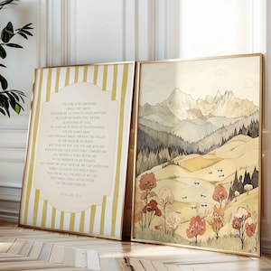 May include: Two framed art prints. One features the text of Psalm 23 in a vertical format with a yellow and white striped background. The other depicts a watercolor landscape of mountains, trees, and sheep in muted tones.