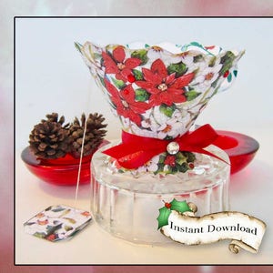 May include: A Christmas-themed tea infuser with a red ribbon and a clear glass base. The infuser is shaped like a cup and features a poinsettia print. The tea bag is also visible in the image. Instant Download.