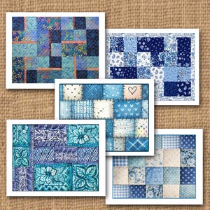 May include: Five greeting cards with patchwork quilt designs in shades of blue. Each card features a different pattern, including floral, paisley, and geometric motifs. The cards are displayed on a textured, tan background.