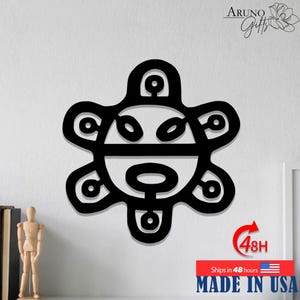 May include: Black, stylized wall art featuring a circular design with a symmetrical, openwork pattern. The art piece has a sun-like appearance. The text "Aruno Gifts" is in the upper right corner. The text "MADE IN USA" is at the bottom.