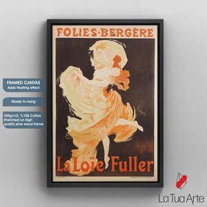 May include: Framed canvas art print of a vintage Folies Berg&egrave;re advertisement, featuring "La Lo&iuml;e Fuller." The artwork shows a dancer in flowing orange and yellow fabric against a dark backdrop, framed in black. The canvas is stretched on a pine wood frame.