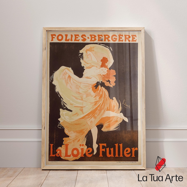 May include: Framed vintage poster with a dancing woman in flowing orange and cream clothing. The poster displays the text "FOLIES-BERGERE" and "La Lo&iuml;e Fuller" against a dark brown backdrop, in a wooden frame.