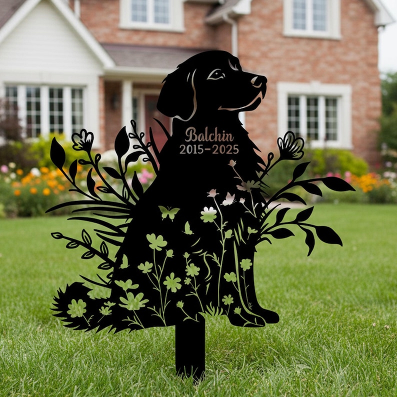 May include: Black metal garden stake with a dog silhouette, floral and butterfly cutouts. The dog's name, "Balchin", and years "2015-2025" are displayed. Suitable for outdoor use, this stake adds a decorative touch to gardens.