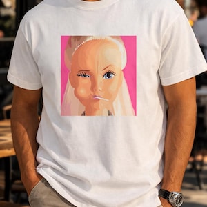 Retro Doll Face Graphic T-Shirt, Funny Pop Art Doll Tee, Y2K Aesthetic Shirt, Quirky Fashion Doll Faces, Trendy Pink Graphic Tee