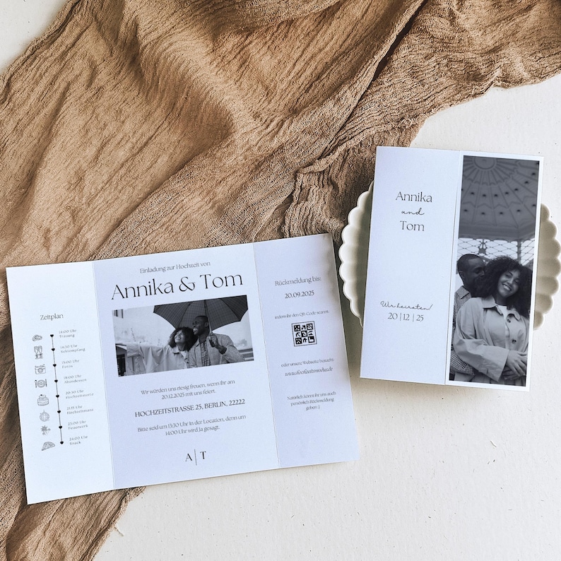 May include: A white wedding invitation with a black and white photo of a couple. The invitation includes the names Annika and Tom, the wedding date, and the location of the wedding. The invitation also includes a QR code.