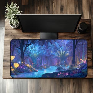 May include: A rectangular mousepad featuring a fantasy forest scene with a river, glowing trees, and mushrooms in shades of blue, purple, and yellow. The mousepad is on a wooden desk with a computer monitor and other accessories.