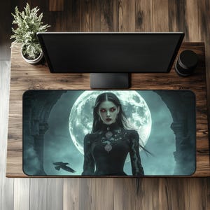 May include: A rectangular black mousepad featuring a gothic fantasy scene. A woman with red eyes and dark clothing stands before a full moon. A raven flies in the foreground. The background includes gothic arches and a teal sky.