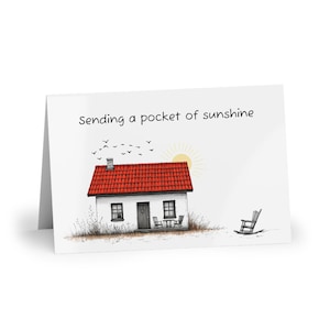 White greeting card with house illustration, "Sending a pocket of sunshine", minimalist card with envelope, blank inside, happy note