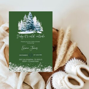 May include: A green baby shower invitation with a winter forest scene. The text "Baby it's cold outside" is at the top, with details for the event, including the date, time, and RSVP information. The invitation is decorated with a snowy border.
