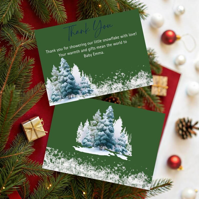 May include: Two green thank you cards with a winter forest design and the text "Thank You". The cards have a snowy forest scene and the message "Thank you for showering our little snowflake with love!"