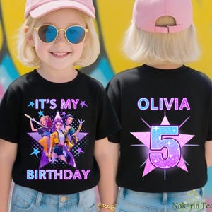 May include: Black t-shirt with the text "IT'S MY BIRTHDAY" and a graphic of three animated figures. The back of the shirt has the name "OLIVIA" and the number "5" in a starburst design. The child is wearing a pink cap and sunglasses.