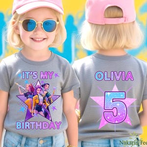 May include: A gray t-shirt with the text "IT'S MY BIRTHDAY" and a graphic of three cartoon characters on the front. The back of the shirt has the name "OLIVIA" and the number "5" on a star. The shirt is worn by a child.