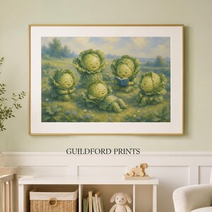 May include: A framed horizontal wall art print titled GUILDFORD PRINTS featuring a whimsical illustration of four anthropomorphic cabbage characters in a grassy field, with one character reading a blue book under a soft blue sky with clouds.