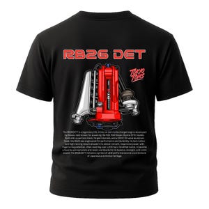 May include: Black t-shirt featuring a red and silver engine graphic with the text "RB26 DET" and "TOKYO TOMS." The graphic depicts a detailed illustration of an engine, showcasing its components. The shirt also includes text describing the engine's features.