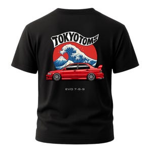 May include: Black t-shirt featuring a red car graphic with the text "EVO 7-8-9" below it. The design includes a red circle with a white wave and a mountain, and the text "TOKYO TOMS" above the wave.