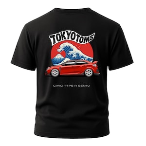 May include: Black t-shirt featuring a red car graphic with the text "TOKYO TOMS" above a wave and mountain design. The text "CIVIC TYPE R GEN10" is below the car.