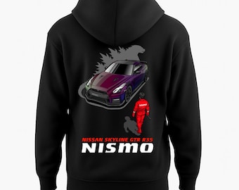 May include: Black hooded sweatshirt featuring a purple and black Nissan Skyline GTR R35 car graphic. The design includes a red-suited figure and the text "NISSAN SKYLINE GTR R35 NISMO" in white.