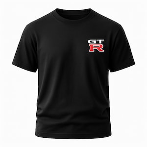May include: Black short-sleeved t-shirt with a white and red "GT-R" logo on the left chest. The logo features the letters "GT" stacked above the letter "R". The shirt is made of a soft, opaque material.