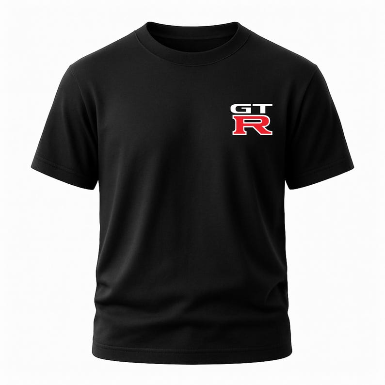 May include: Black short-sleeved t-shirt with a white and red "GT-R" logo on the left chest. The logo features the letters "GT" stacked above the letter "R". The shirt is made of a soft, opaque material.