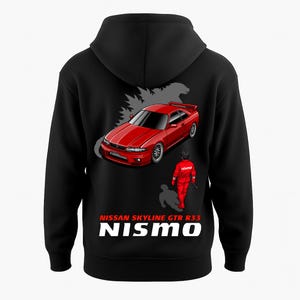 May include: Black hoodie featuring a red Nissan Skyline GTR R33 graphic, a driver in a red racing suit, and the text "NISSAN SKYLINE GTR R33 NISMO". The design includes a gray silhouette of a monster.