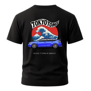 May include: Black t-shirt featuring a blue car graphic with the text "TOKYO TOMS" above a wave and mountain design. The text "CIVIC TYPE R GEN11" is below the car.