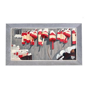 May include: A framed painting depicts a row of red and white lobster buoys hanging against a weathered gray wooden wall. The buoys are topped with white snow. The painting is in a gray frame.