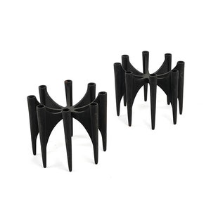 May include: Two black metal candle holders with a geometric design. Each holder has eight candle slots.