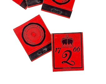 May include: Several red and black matchbooks are scattered across a white background. One matchbook displays the number "2" with "1766" above it and a crown. The text "Made in U.S.A." is printed at the bottom.