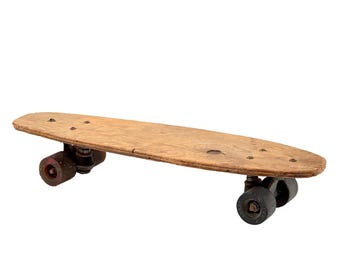 May include: A vintage wooden skateboard with black wheels and red metal trucks. The skateboard is in good condition with some wear and tear.