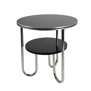May include: A small, black side table with a round top and a lower shelf. The table has a chrome-colored metal frame and measures approximately 20 inches in diameter and 24 inches high.
