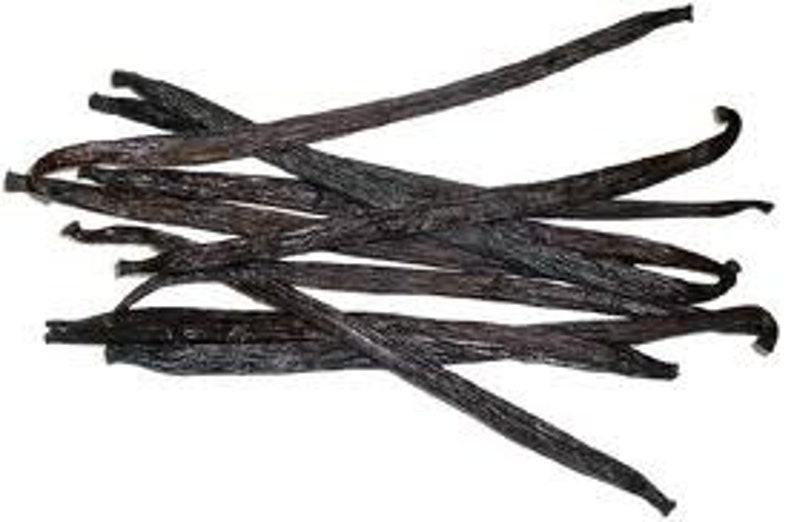 May include: A bunch of whole vanilla beans, dark brown in color, with a slightly shiny surface. The beans are arranged in a random pattern, with some overlapping.