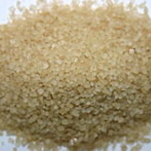 May include: A close-up view of light brown granulated sugar crystals.