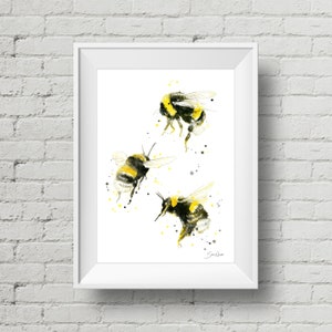 May include: Watercolor painting of three bumblebees in flight. The bees are painted in shades of yellow and black with white accents. The background is white with yellow and gray splatters.