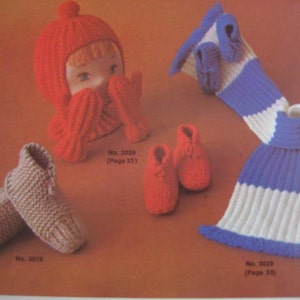 May include: A set of three knitted items: a red hat with a white pom-pom, a pair of brown knitted slippers, and a blue and white striped scarf with a knitted fringe. The items are labeled with numbers and page numbers.