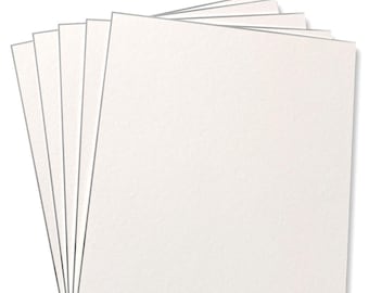 May include: A stack of white cardstock paper. The paper is smooth and has a slight texture.
