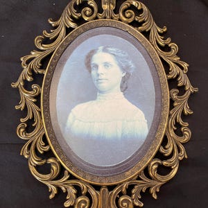 Vintage Ornate Oval frame with a female figure.