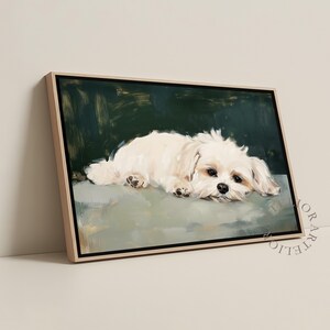 May include: A framed canvas print featuring a white dog lying down. The dog has dark eyes and black paw pads. The background is a dark green with brushstrokes, and the dog rests on a light blue-green surface.