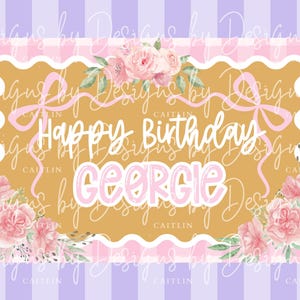May include: A birthday-themed design with the words "Happy Birthday Georgie" in a playful font. The design features a gold-colored scalloped frame with pink gingham and floral accents, set against a striped background.