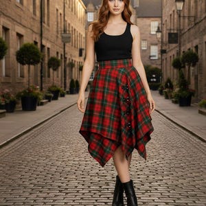 May include: A red and green plaid skirt with a unique asymmetrical hemline and button details. The skirt is paired with a black tank top and black boots. The outfit is set against a cobblestone street backdrop.